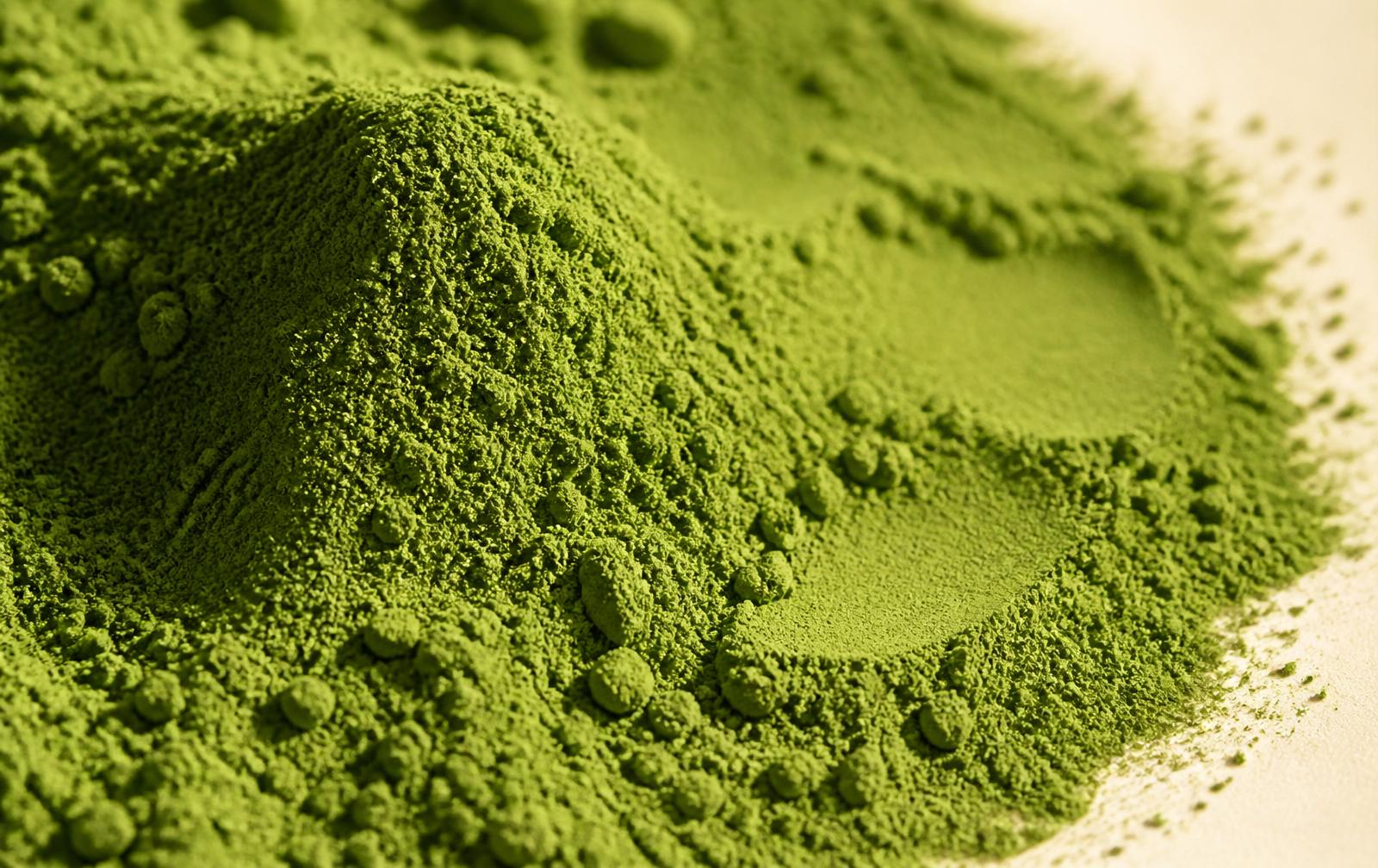 Close-up macro of vivid emerald matcha powder.